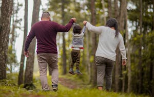A family walking through a forest